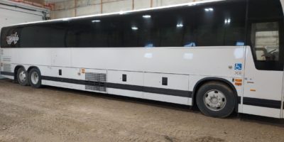 The white bus of Paradigm Bus Charter, which provides excellent bus transportation services in Saskatchewan.